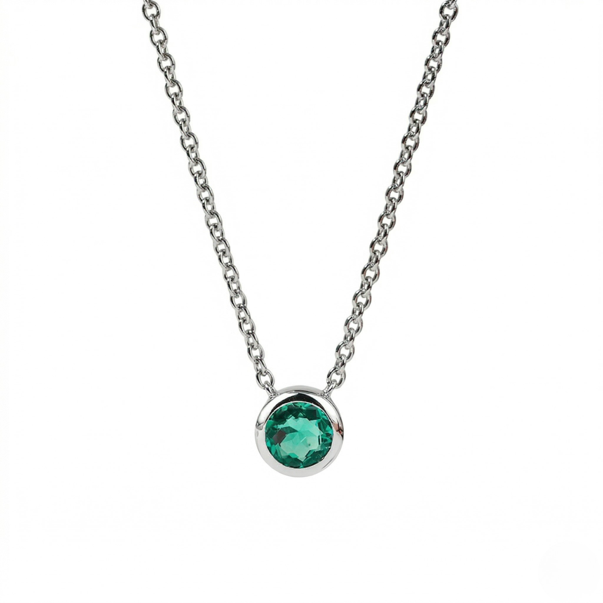 Necklace with a green gemstone on a white background - Emerald Necklace Bezel - J. Collins 