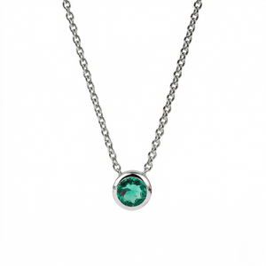 Necklace with a green gemstone on a white background - Emerald Necklace Bezel - J. Collins 