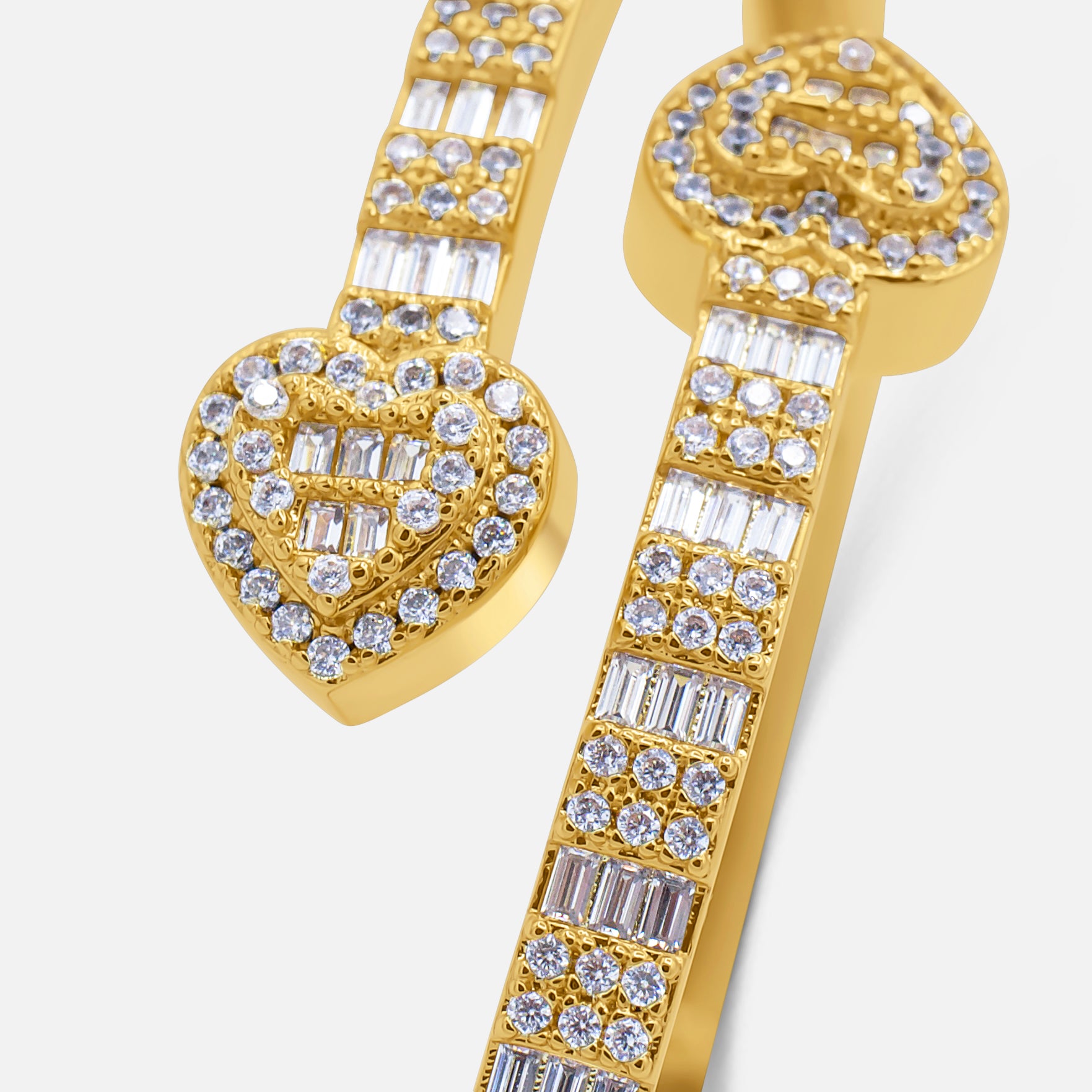 Gold earrings with heart and key designs and clear gemstones on a white background-Empress-Cuff-J.Collins-Jewelry