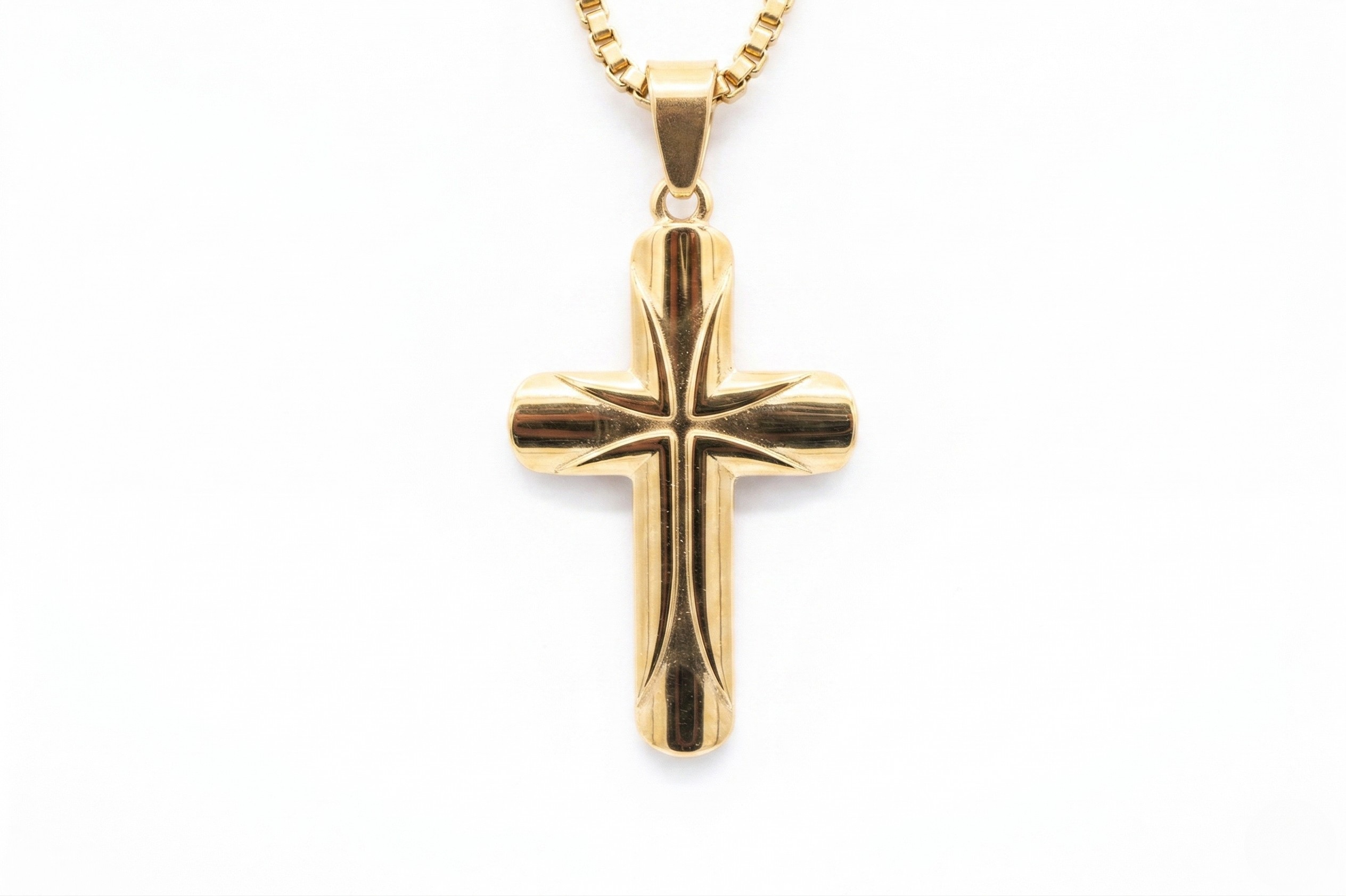 Gold cross pendant on a white background- J.Collins Jewelry