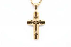 Gold cross pendant on a white background- J.Collins Jewelry