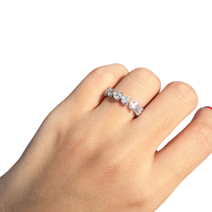 A model's hand wearing a moissanite ring against a white background-J.Collins Jewelry