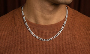 Silver chain necklace on a person wearing a brown shirt against a brown background-J.Collins Jewelry