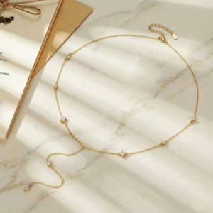 Gold necklace with small diamonds on a marble surface-J.Collins Jewelry