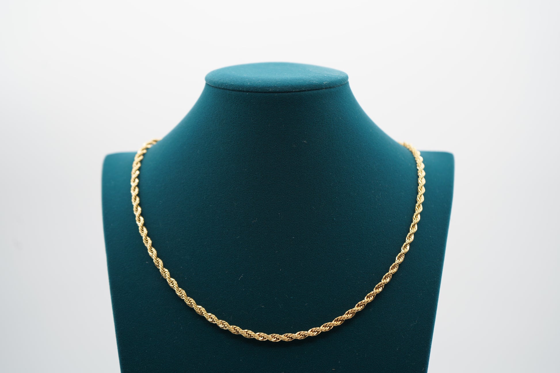 Gold chain necklace on a green mannequin bust against a white background-Vermiel-Rope-Chain-JCollins-Jewelry