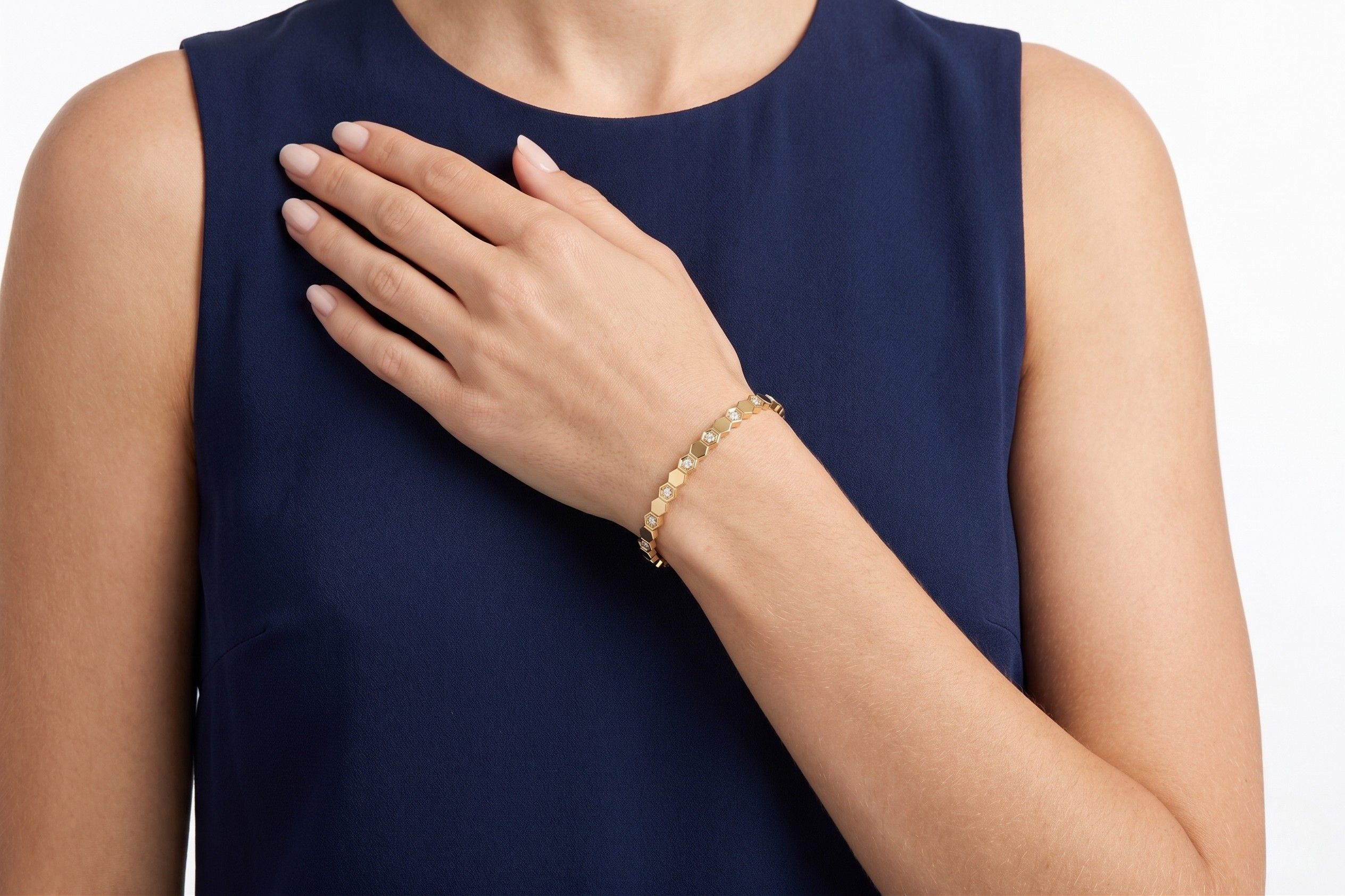 Woman wearing a gold bracelet on a navy-blue sleeveless top- J.Collins Jewelry
