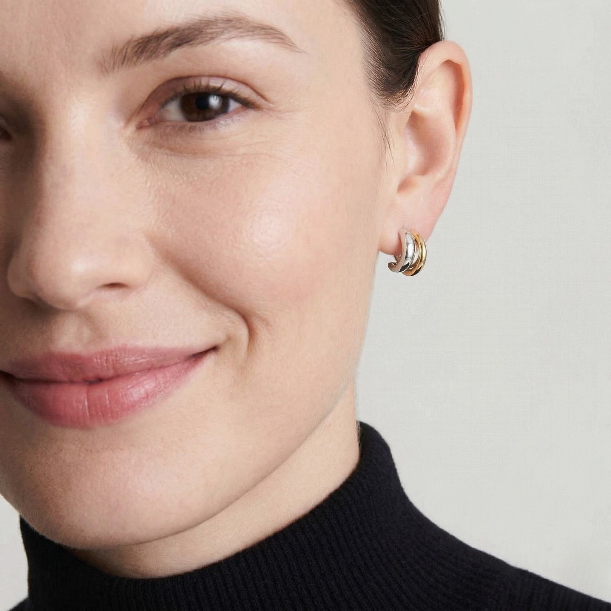 Woman wearing double bind earrings with a neutral background-J.Collins Jewelry