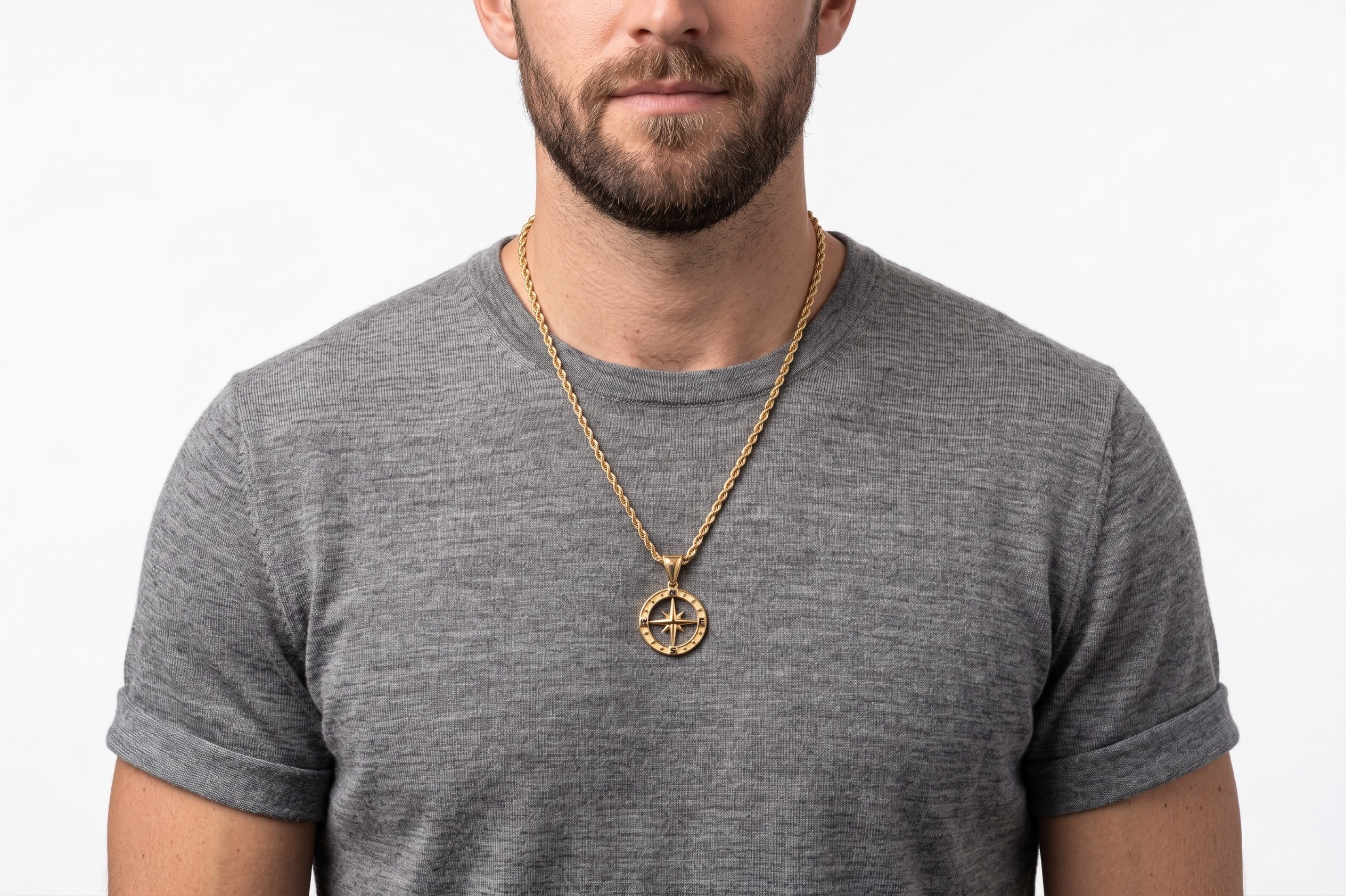 Man wearing a gray t-shirt and gold necklace with a compass pendant on a white background-J.Collins Jewelry