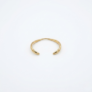 Gold open cuff on a white background- J.Collins Jewelry