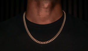 Gold chain necklace on a black background -Iconic-Cuban-Chain-JCollins-Jewelry
