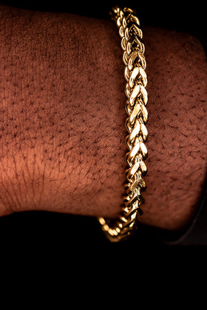 Gold chain bracelet on a wrist against a dark background-Signature-Franco-Bracelet-JCollins-Jewelry