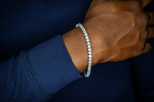 Close-up of a hand wearing a diamond bracelet with a dark background-Tennis-Silver-Bracelet-JCollins-Jewelry