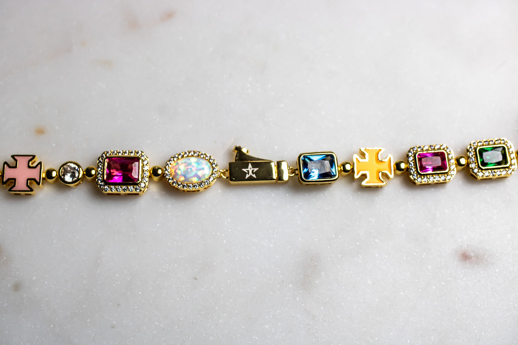 Gold bracelet with colorful gemstones on a light marble - MultiColored-Regal-Gem-Chain-JCollins-Jewelrybackground