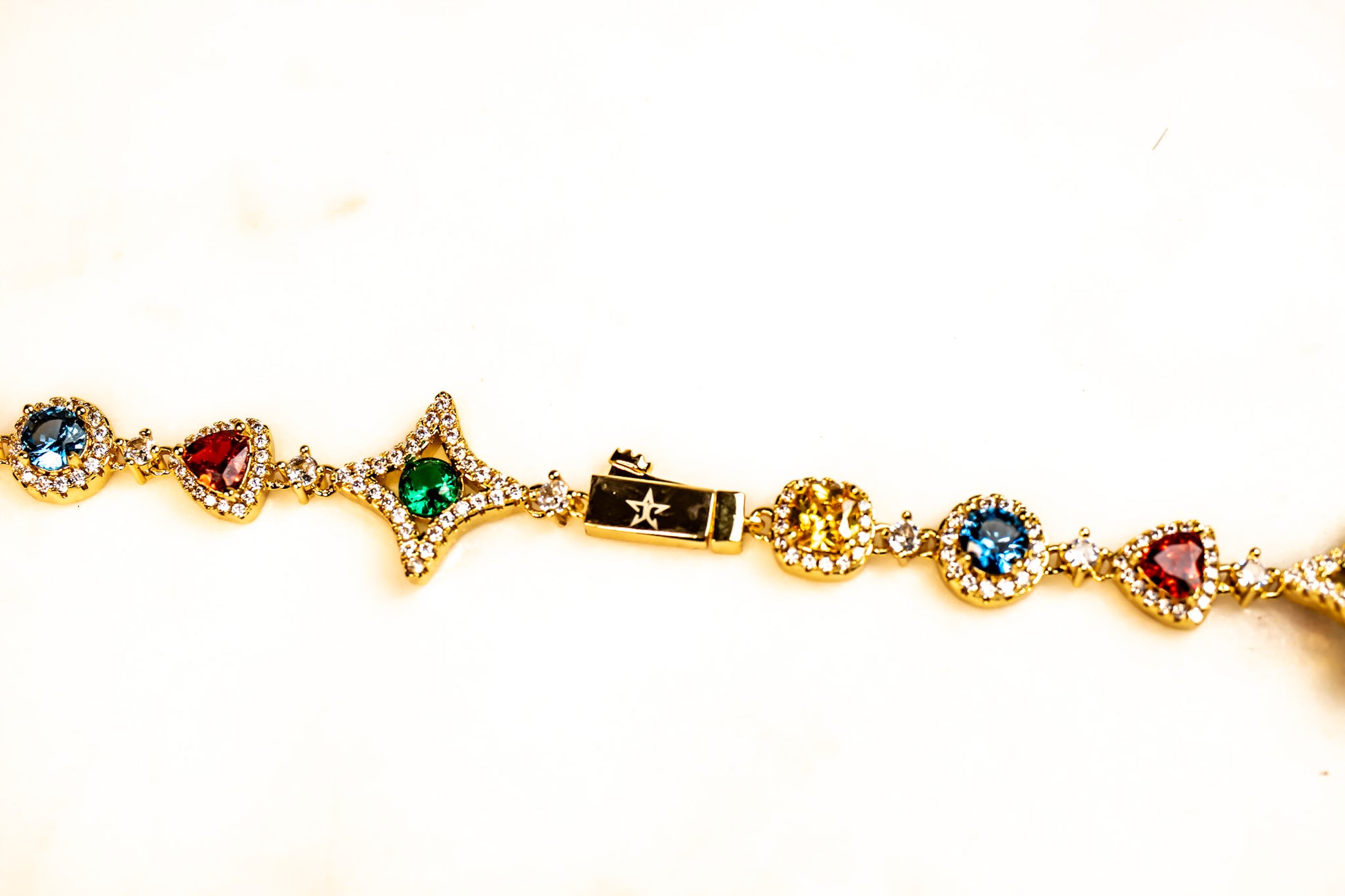Gold bracelet with colorful gemstones on a white background-Multi-Gem-Chain-JCollins-Jewelry