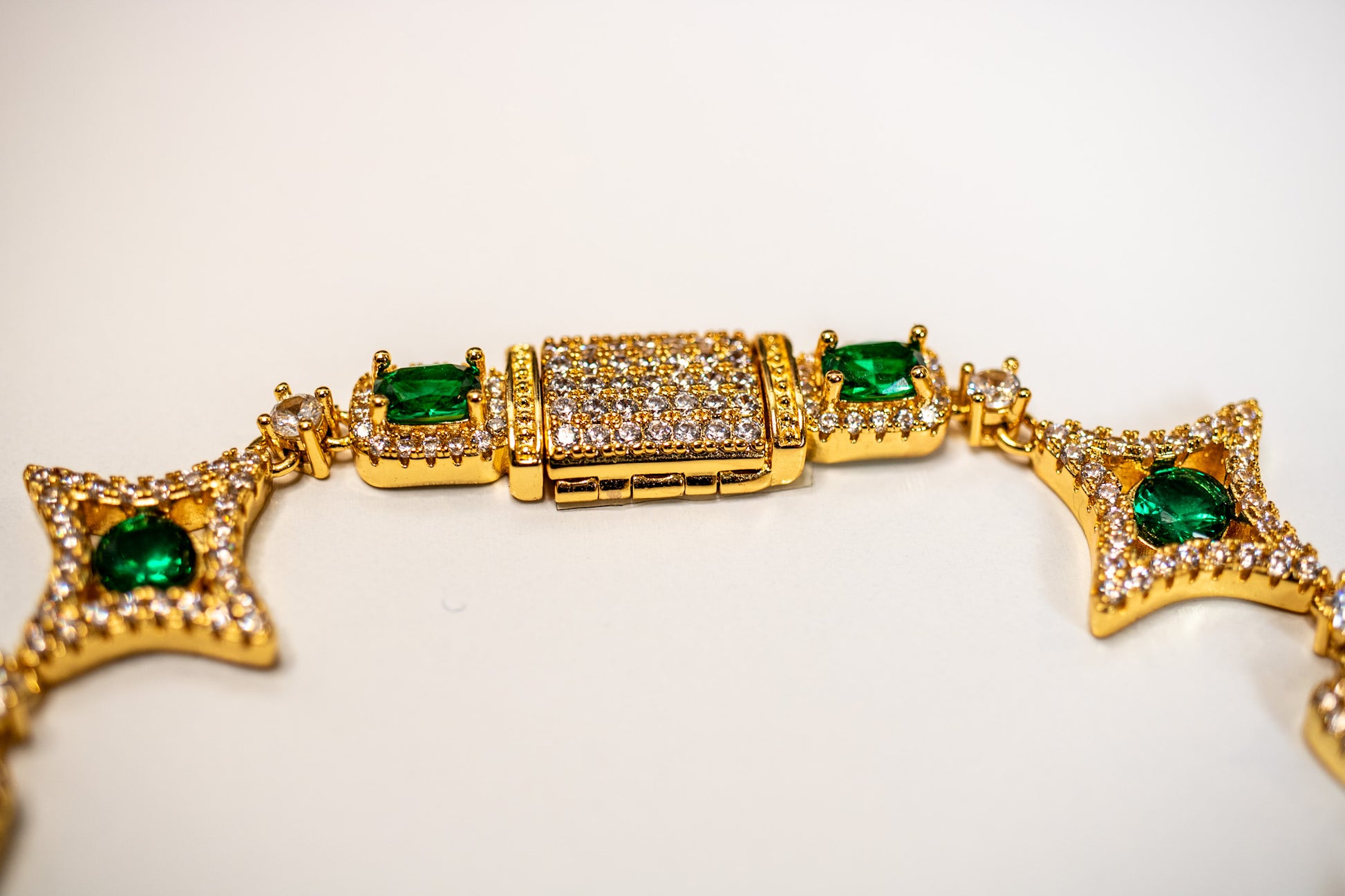 Gold bracelet with green gemstones on a light background- Multicolor-Gemstone-Bracelet JCollins-Jewelry