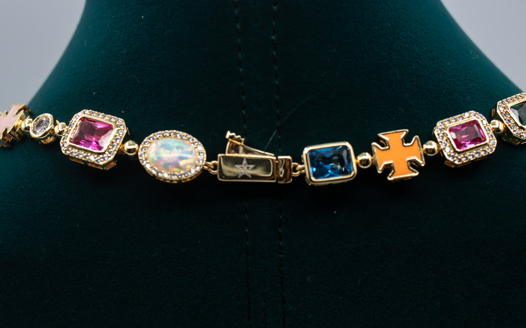 Gold bracelet with colorful gemstones on a black stand- MultiColored-Regal-Gem-Chain-JCollins-Jewelry