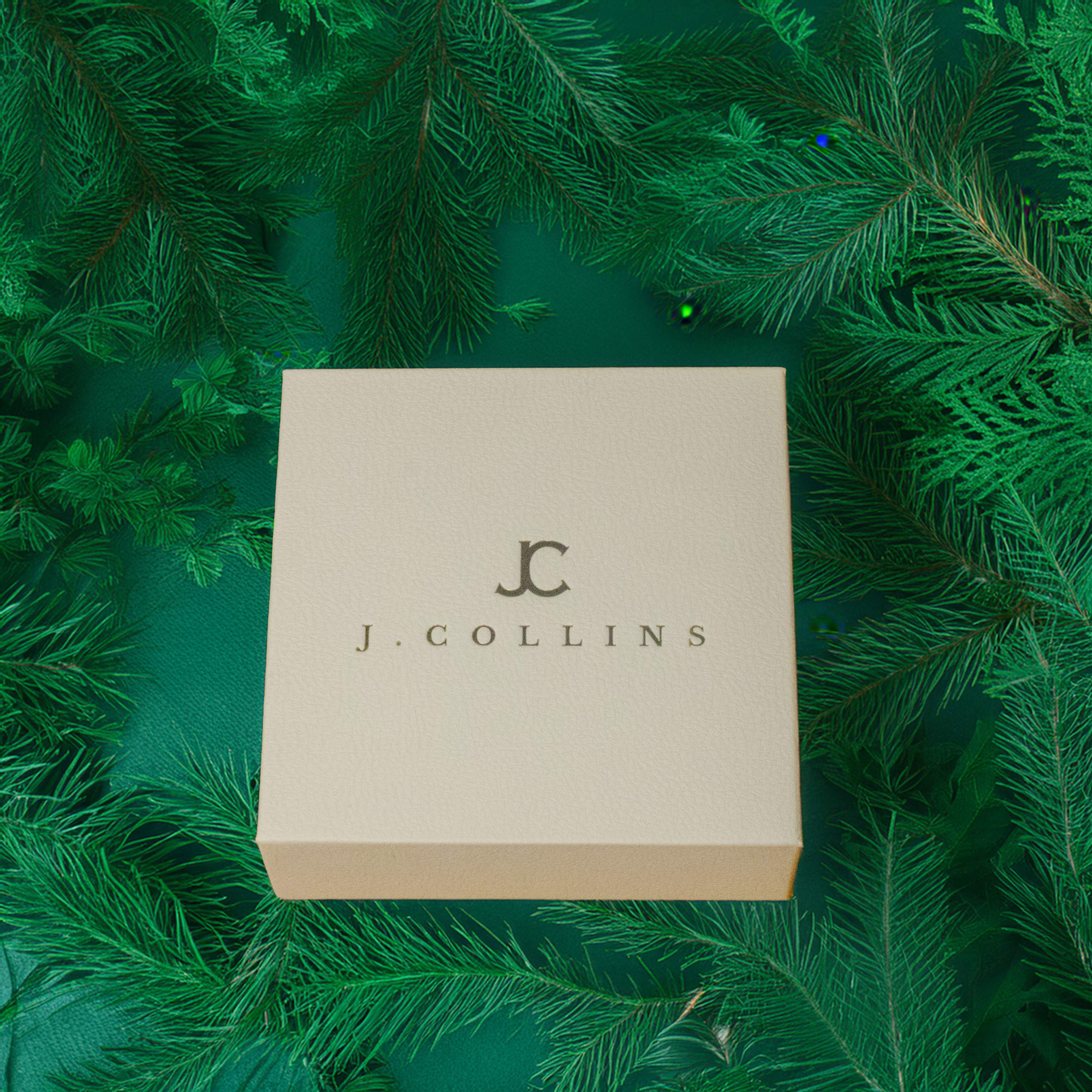 J. Collins box on a green leafy background