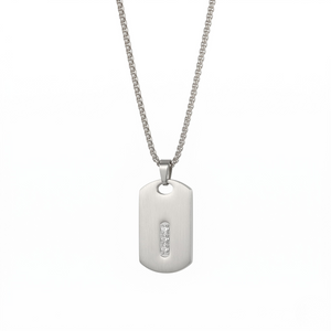 Silver dog tag necklace with a small diamond on a white background-J.Collins Jewelry