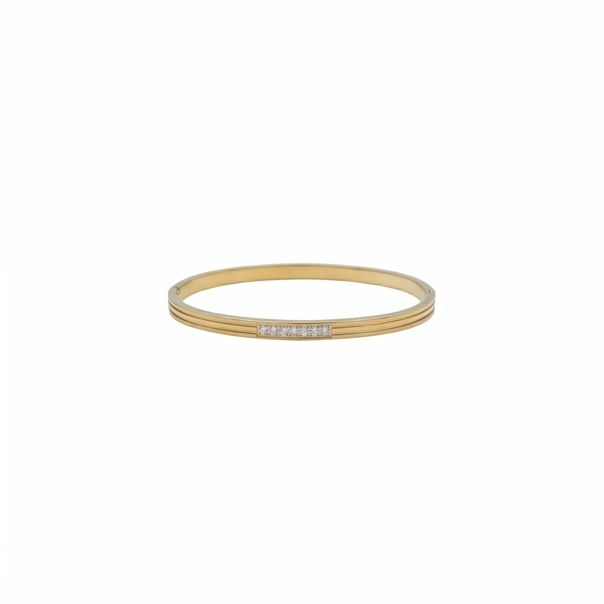 Gold bangle with embedded stones on a white background-J.Collins Jewelry