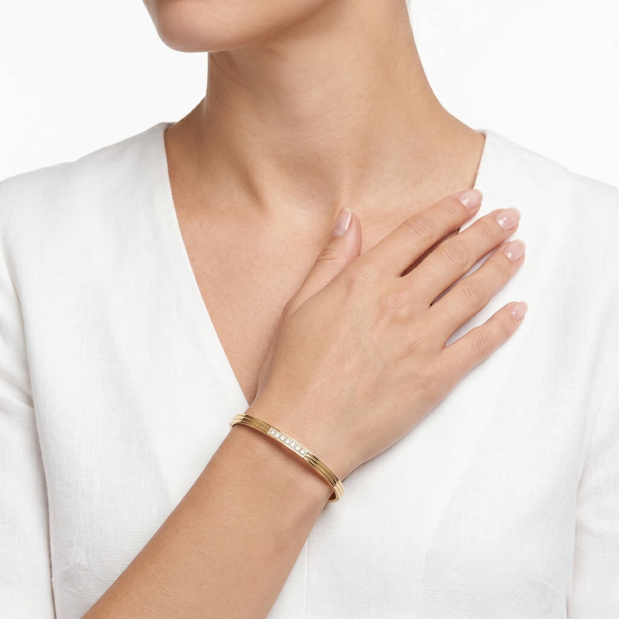 Gold bracelet on a wrist with a white background-J.Collins Jewelry