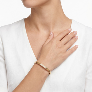 Gold bracelet on a wrist with a white background-J.Collins Jewelry