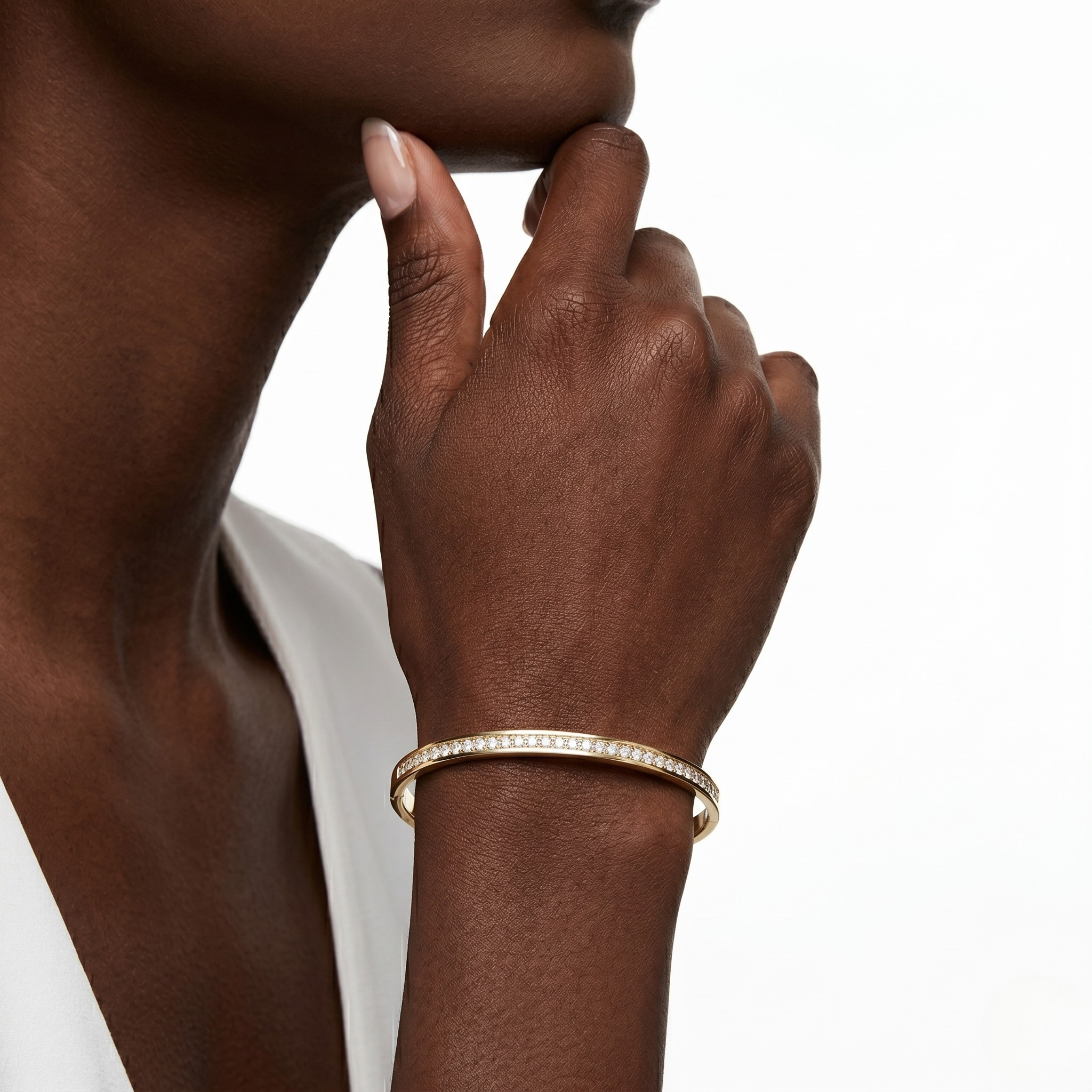 Hand wearing a gold bracelet on a white background- J.Collins Jewelry