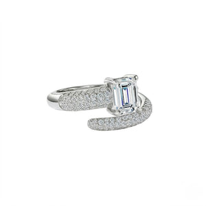 A silver-toned ring featuring a central emerald-cut clear gemstone and pavé-set side stones, shown on a plain white background - J.Collins Jewelry