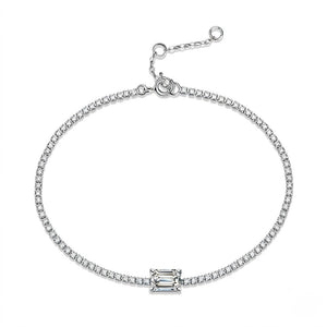 A white gold chain bracelet with a central rectangular baguette-cut clear gemstone, displayed on a clean white background - J.Collins Jewelry