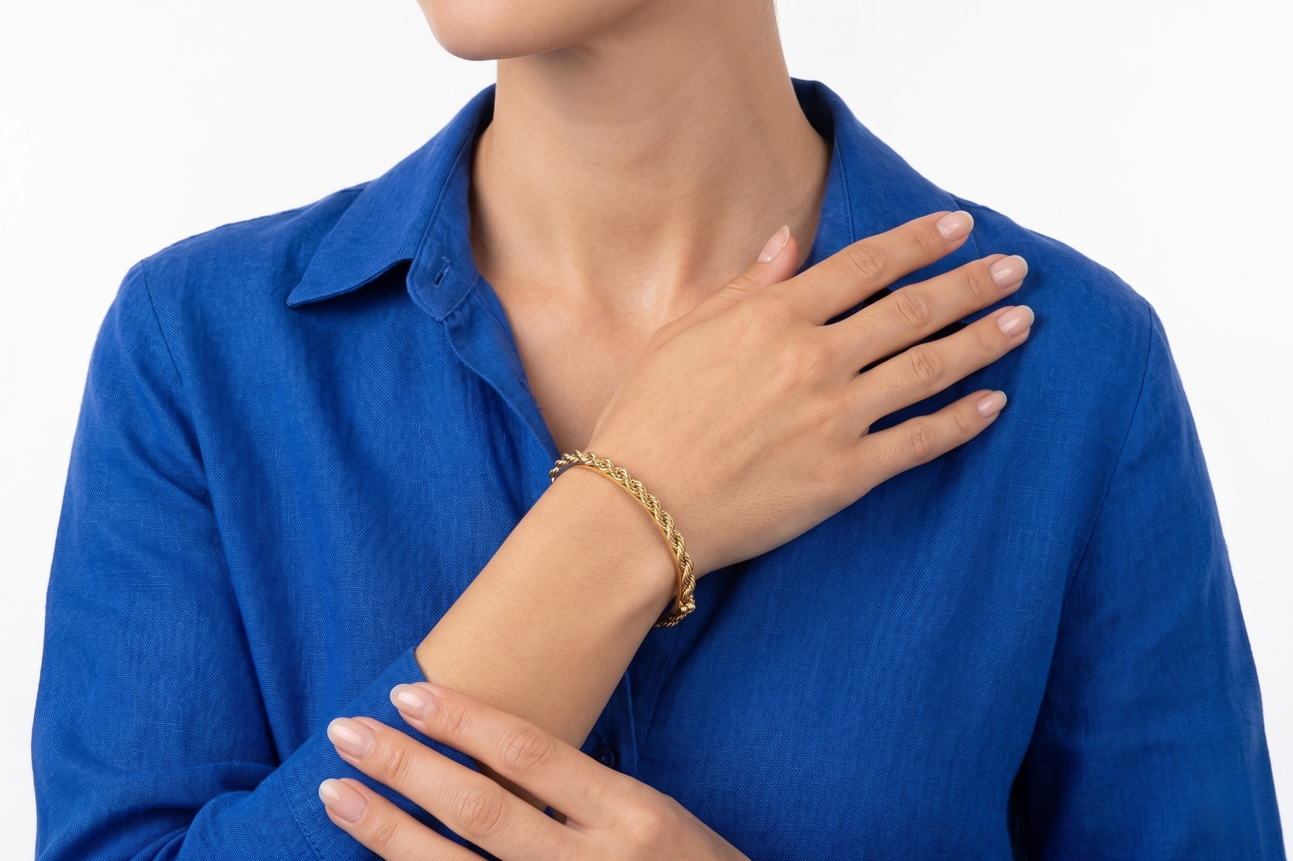 Person wearing a blue shirt with a gold bracelet on a white background-J.Collins Jewelry
