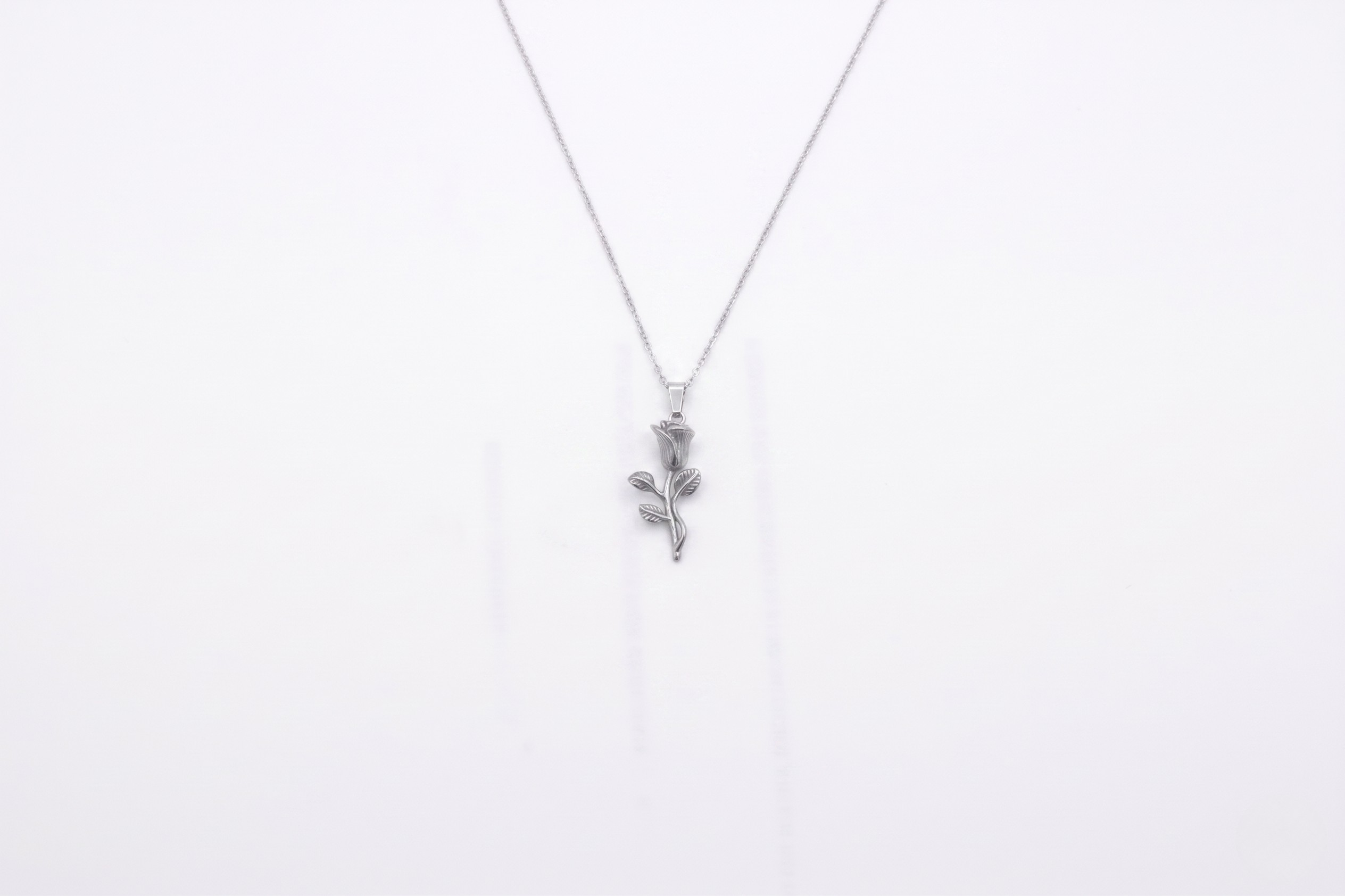 Silver necklace with a floral pendant on a white background- J.Collins Jewerly