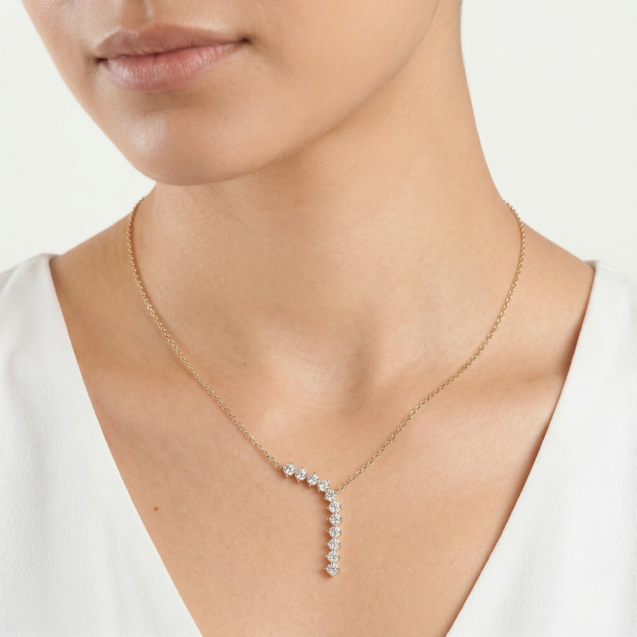 Necklace with a diamond waterfall on a person wearing a white top on a white background-J.Collins Jewelry
