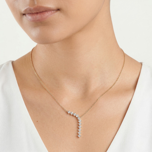 Necklace with a diamond waterfall on a person wearing a white top on a white background-J.Collins Jewelry