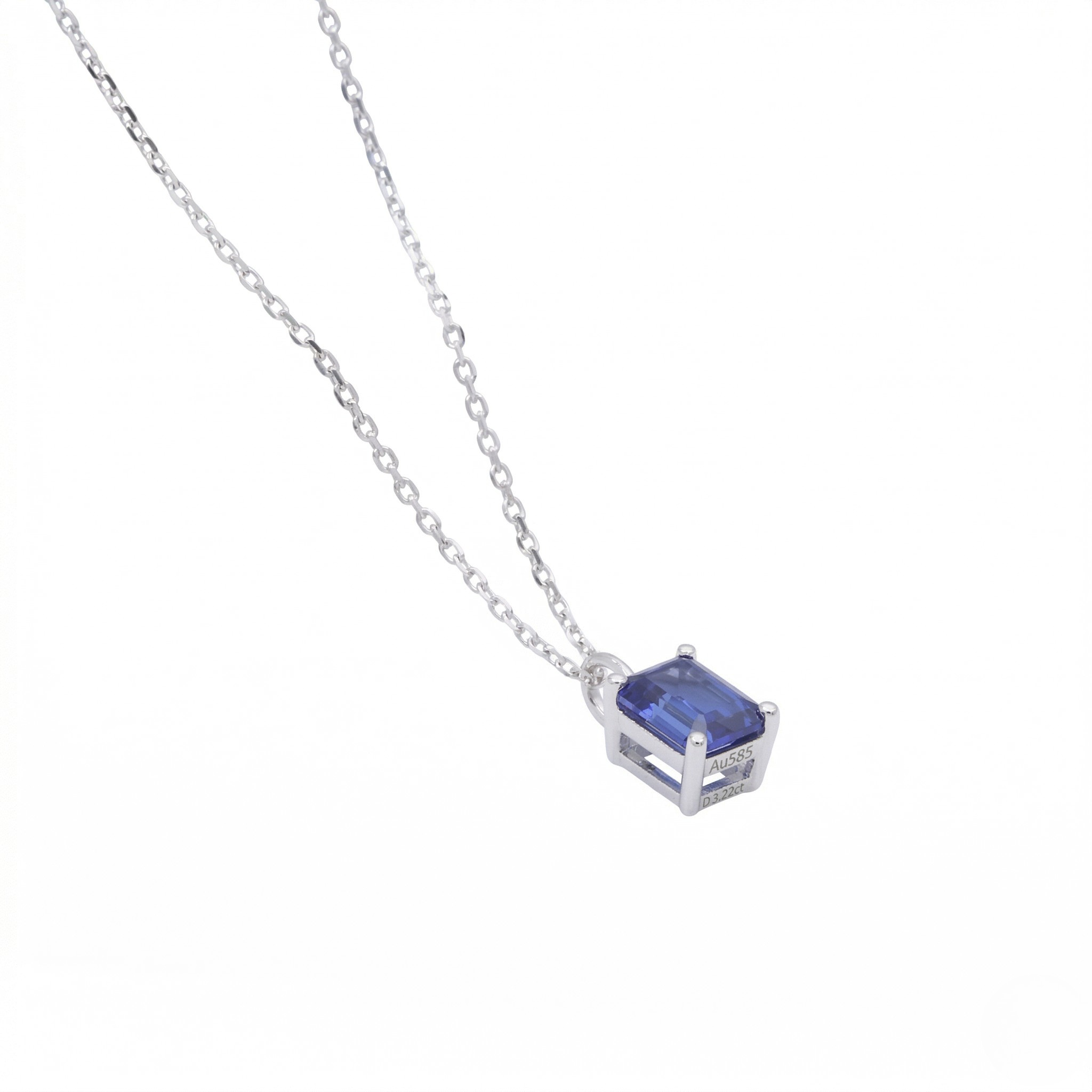 Silver necklace with a blue gemstone pendant on a white background - Sapphire Pendant Necklace - J. Collins Jewelry 