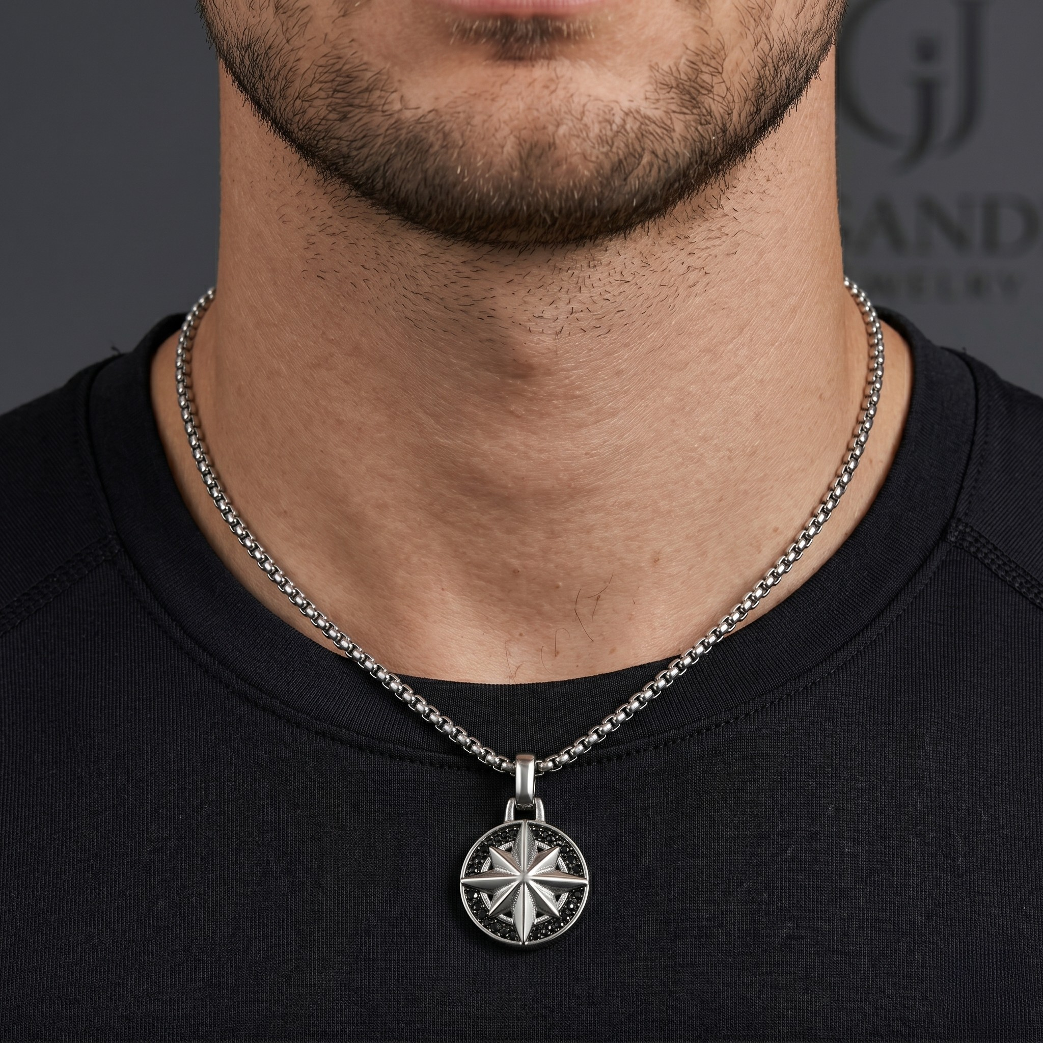 Man wearing a black shirt with a silver necklace featuring a circular pendant - Savana Star Pendant (Silver) - J. Collins Jewelry 
