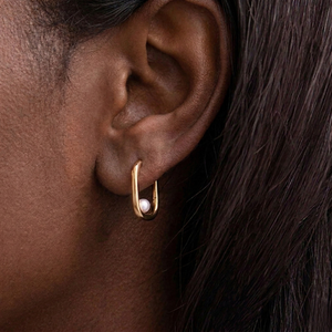 Gold hoop earrings with pearl centers on a model-J.Collins Jewelry
