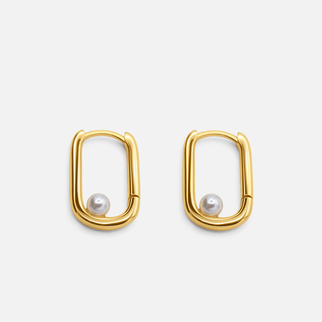 Gold hoop earrings with pearl centers on a white background  - Selene Pearl Hoops - JCollins Jewelry 
