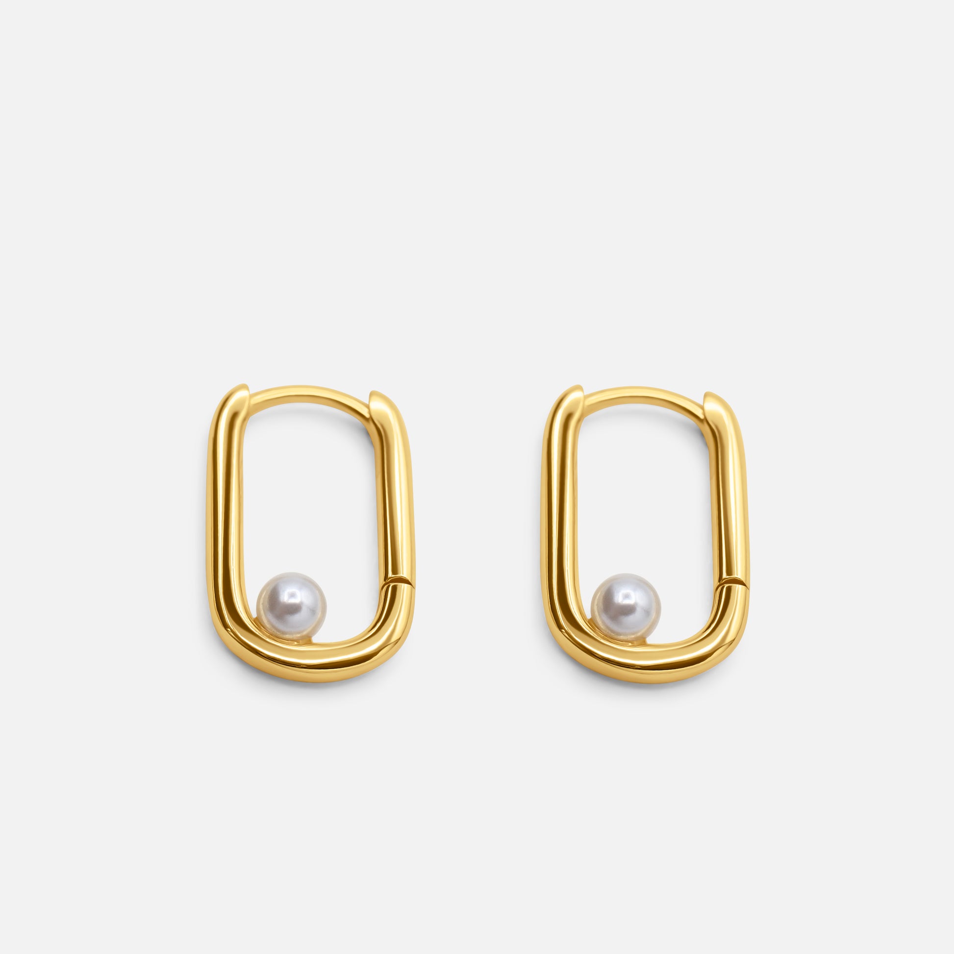 Gold hoop earrings with pearl centers on a white background  - Selene Pearl Hoops - JCollins Jewelry 