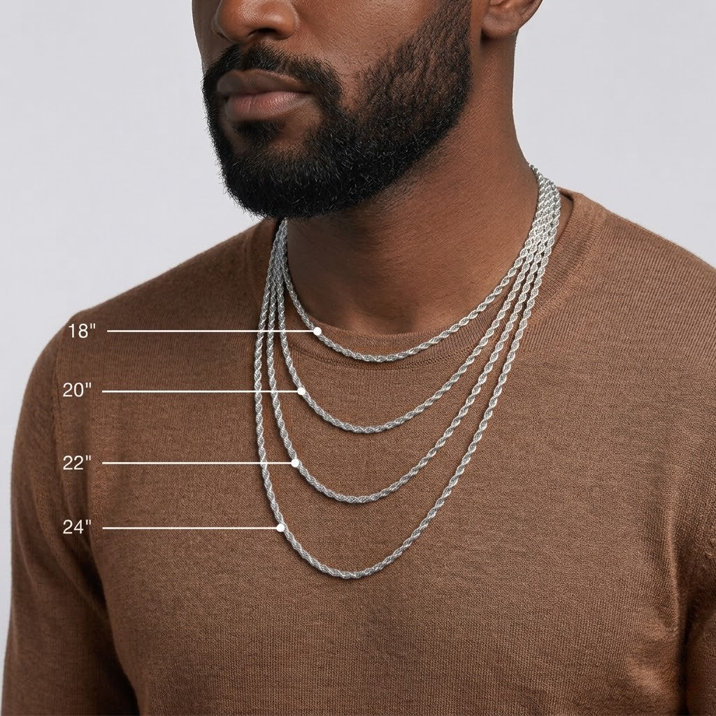 A man wearing layered silver chain necklaces at different lengths (18", 20", 22", 24") over a brown knit sweater, with white measurement lines and text labels indicating the lengths - J.Collins Jewelry