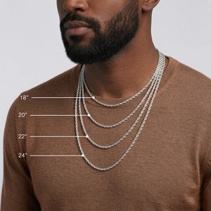 A man wearing layered silver chain necklaces at different lengths (18", 20", 22", 24") over a brown knit sweater, with white measurement lines and text labels indicating the lengths - J.Collins Jewelry