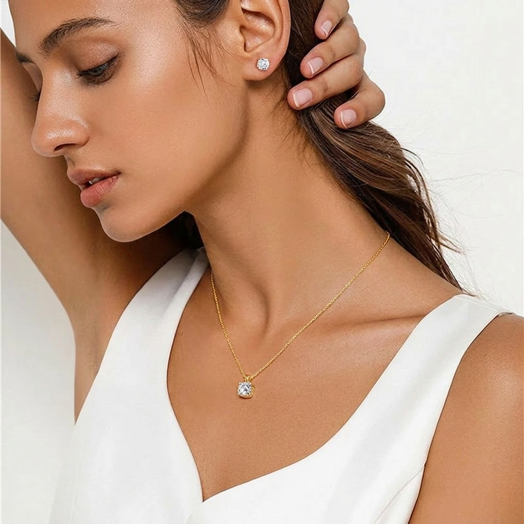 Woman wearing a gold necklace and earrings on a white background-J.Collins Jewelry