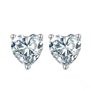 A pair of heart-shaped diamond stud earrings in a silver four-prong setting, shown against a plain white background. J.Collins Jewelry 