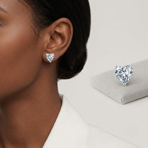 Sterling silver moissanite flower cluster stud earrings worn on earlobe. J.Collins Jewelry 