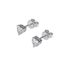 A pair of silver stud earrings with heart-shaped clear gemstones, shown on a plain white background. J.Collins Jewelry 
