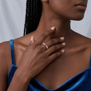 Sterling silver open cuff wrap ring with micro-paved cubic Moissanite tips worn on hand by model wearing a blue velvet top by J.Collins