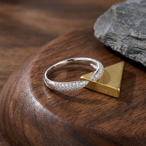
Sterling silver open cuff wrap ring with micro-paved cubic Moissanite crystal tips displayed on a wooden pedestal with brass geometric accent by J.Collins
