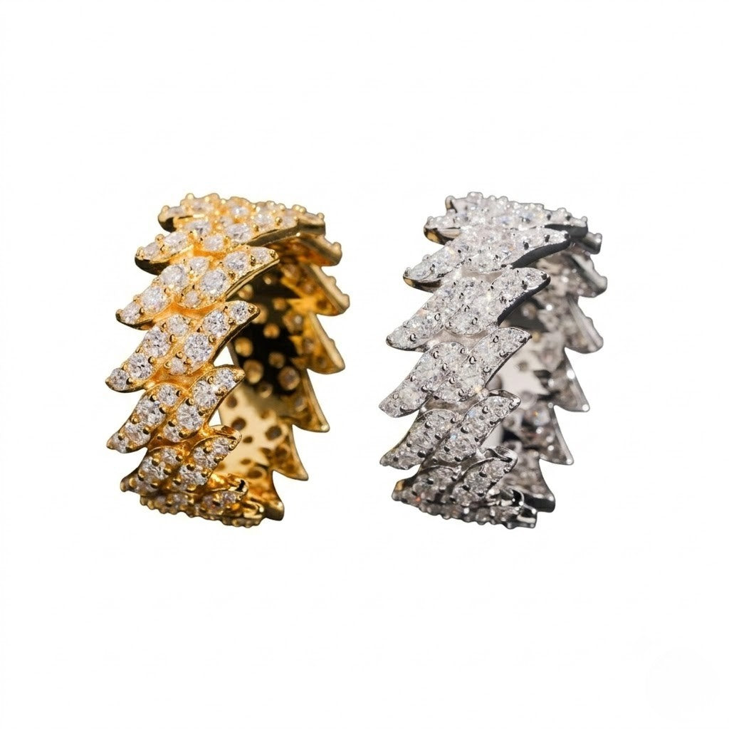 Two textured, tiered hoop-style rings with pavé-set clear stones, shown side by side in yellow gold and silver-tone metal on a plain white background - J.Collins Jewelry