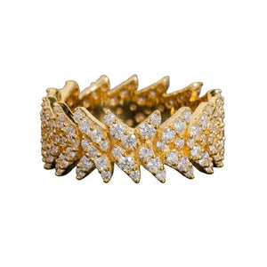 A gold band ring featuring a wide, jagged chevron pattern paved with clear round gemstones, shown against a plain white background - J.Collins Jewelry