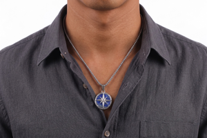 Man wearing a dark gray shirt with a necklace featuring a blue and silver pendant- J.Collins Jewelry