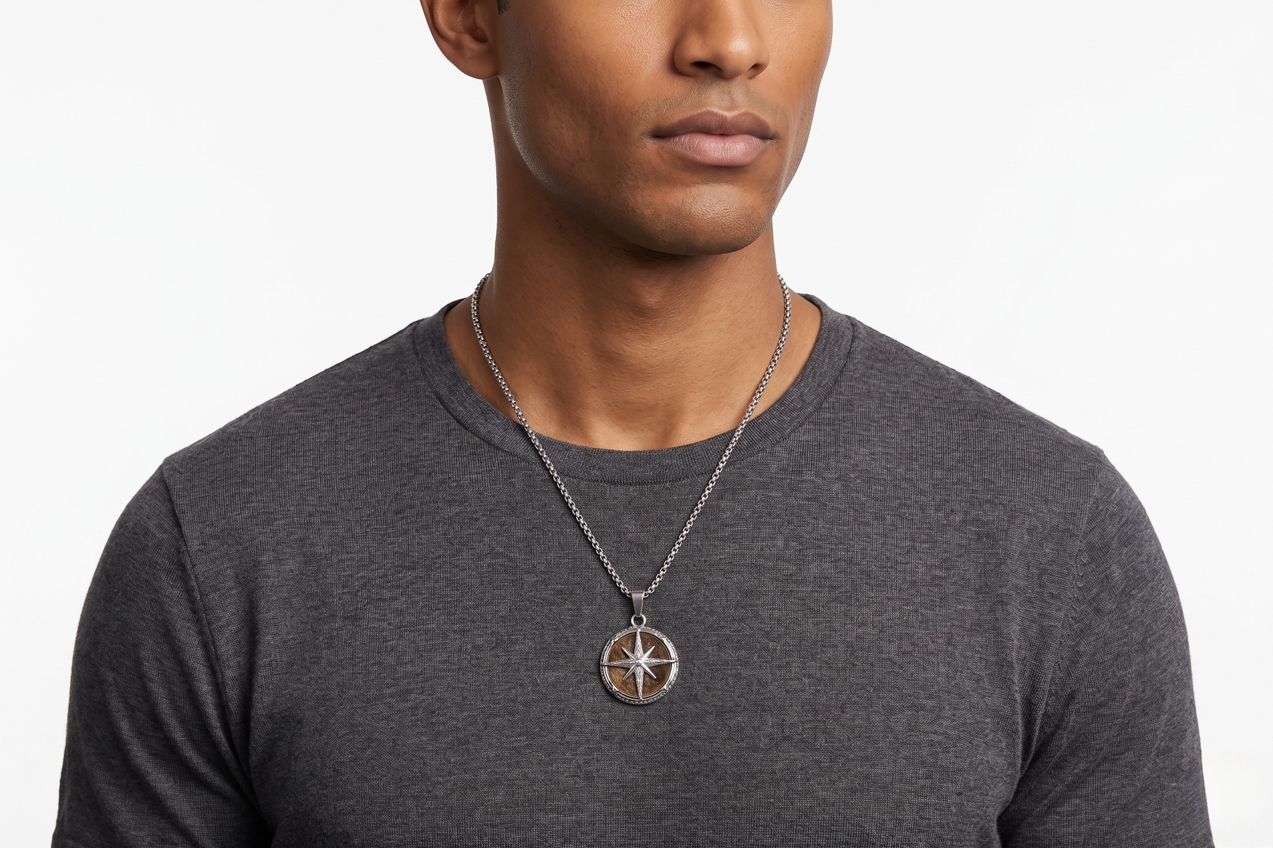 Man wearing a dark gray shirt with a necklace featuring a compass pendant on a white background-J.Collins Jewelry