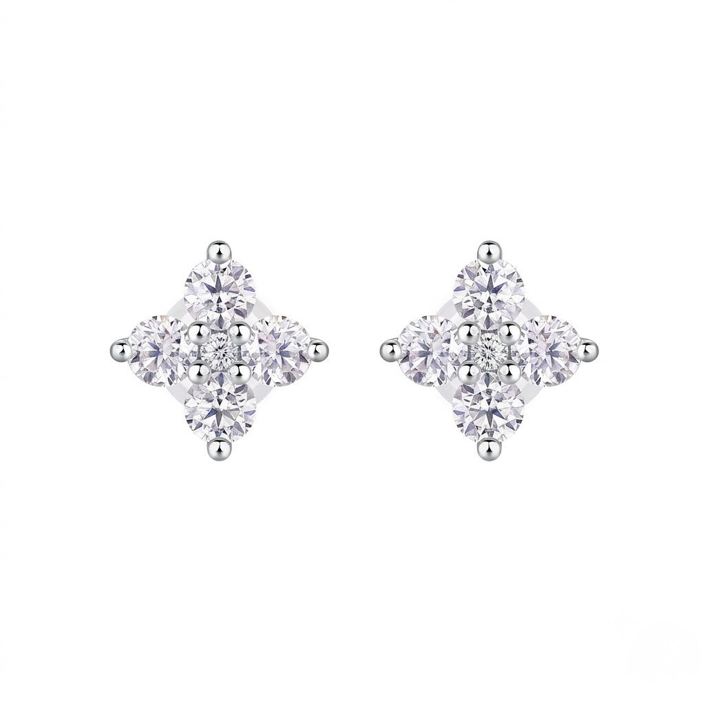 A pair of silver stud earrings featuring a four-stone cluster design in a diamond shape, set against a plain white background. J.Collins Jewelry 